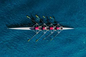 Rowing team on blue water