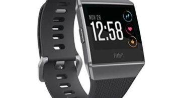 Black silver and gray fitbit ionic watch with 12:58 PM showing on it's LED screen