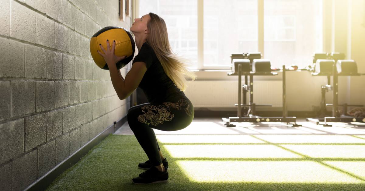 woman doing exercise with medicine ball
