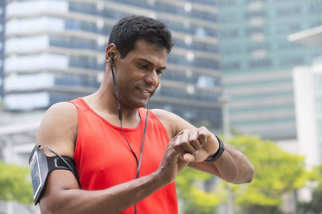 male runner looking at his smartwatch