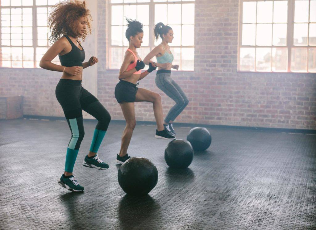 several females exercising with exercise ball