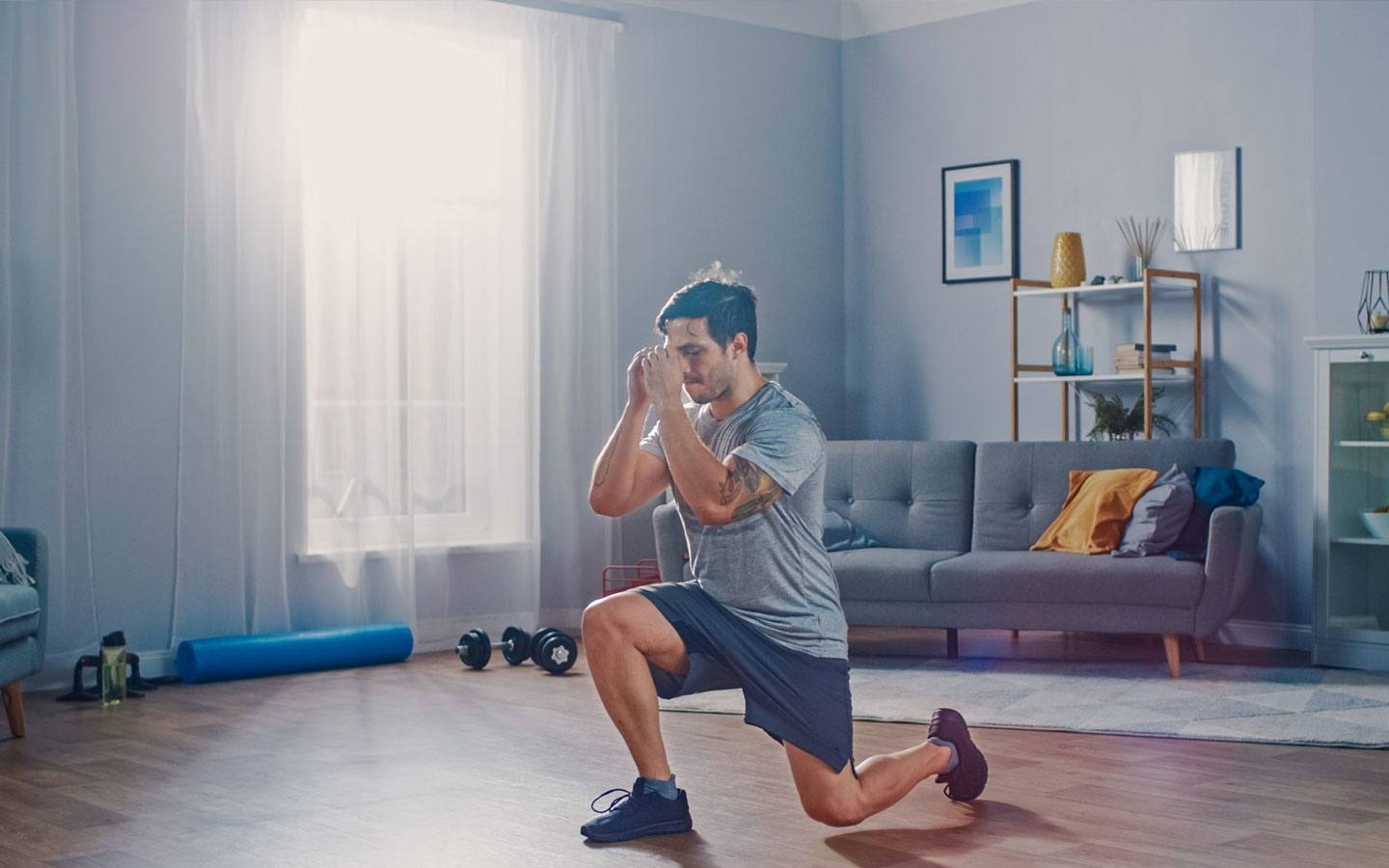 Man doing lunges in living room