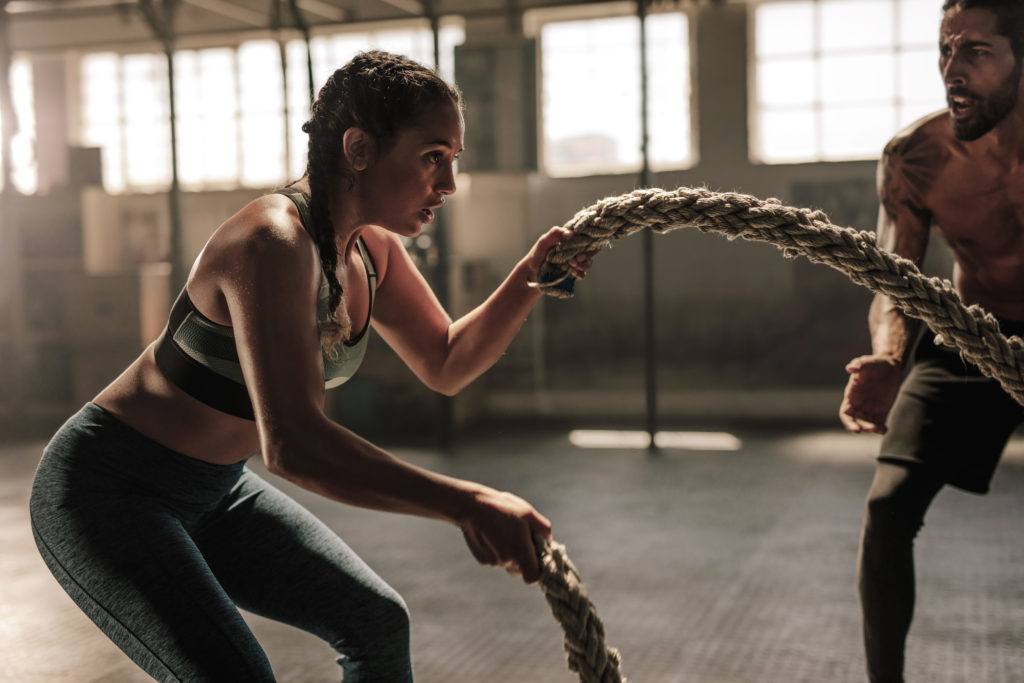 Woman exercising with battle ropes