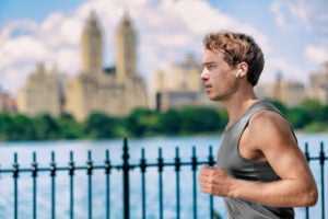 Wireless earbuds man running in Central Park New York City