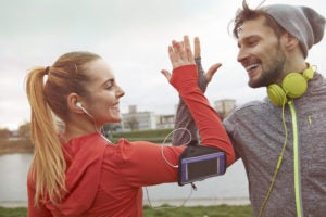 Couple high fiving in workout gear